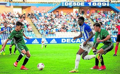 El verdiblanco Juanjo pretende controlar un balón bajo la atenta mirada del recreativista Traoré. El verdiblanco Juanjo pretende controlar un balón bajo la atenta mirada del recreativista Traoré.
